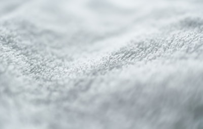Close-up of a soft white t-shirt fabric texture.
