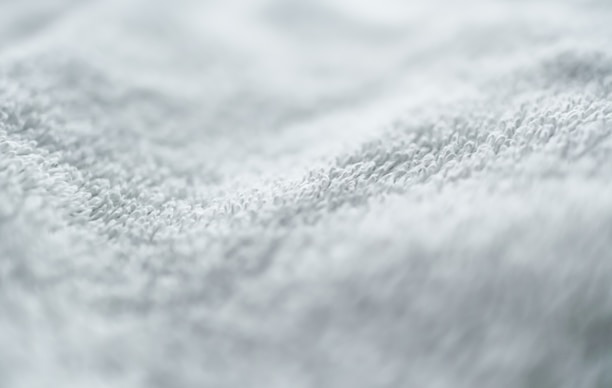 Close-up of a hand feeling the plush texture of a funsat mart llc towel.