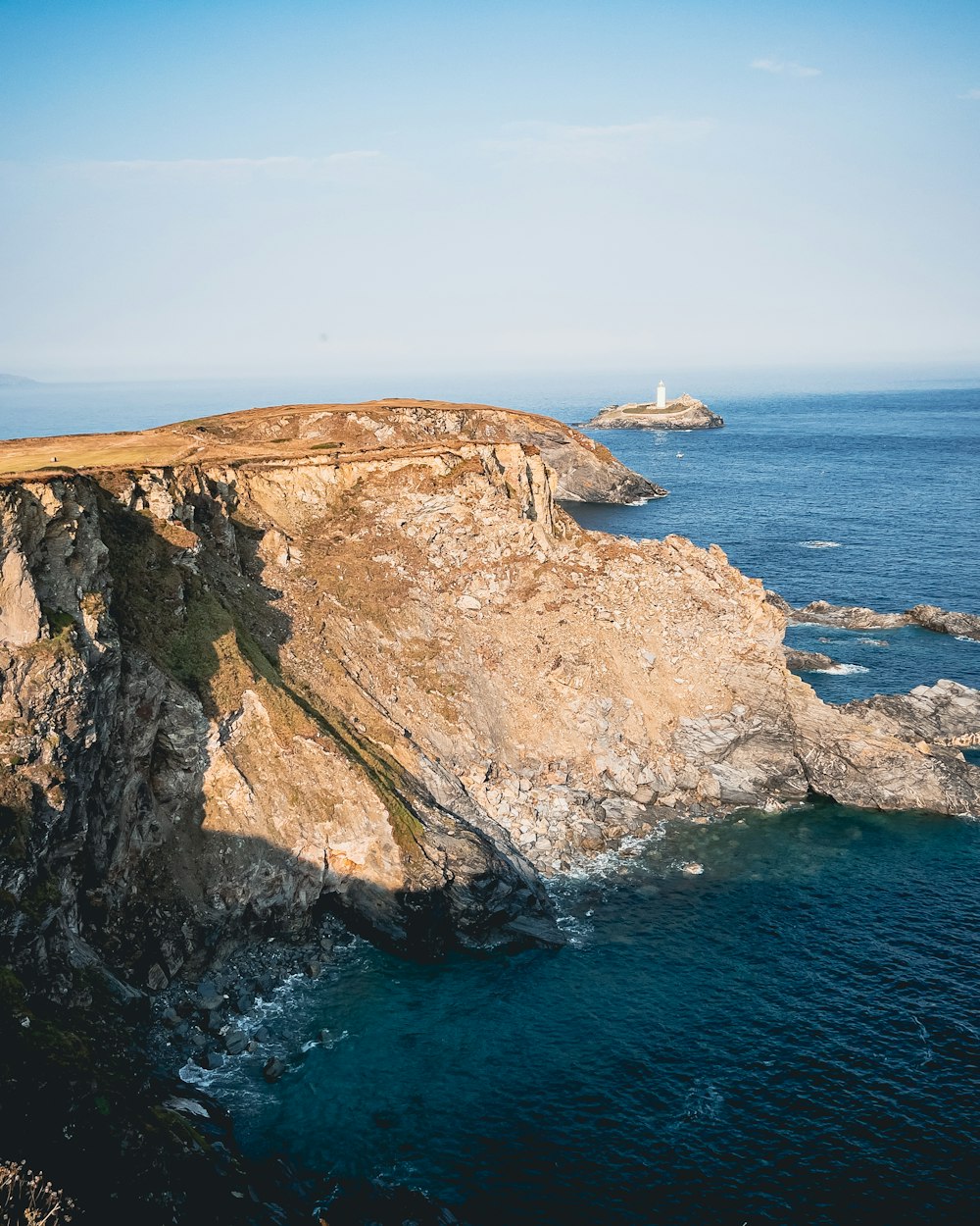 a large rock outcropping in the middle of the ocean