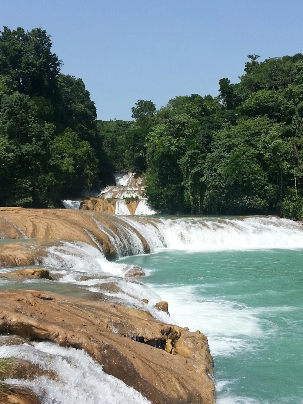 a river with a waterfall in the middle of it