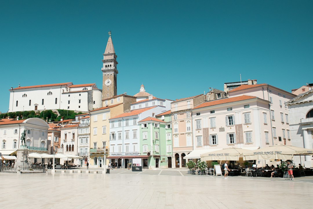 a town square with a clock tower in the background,