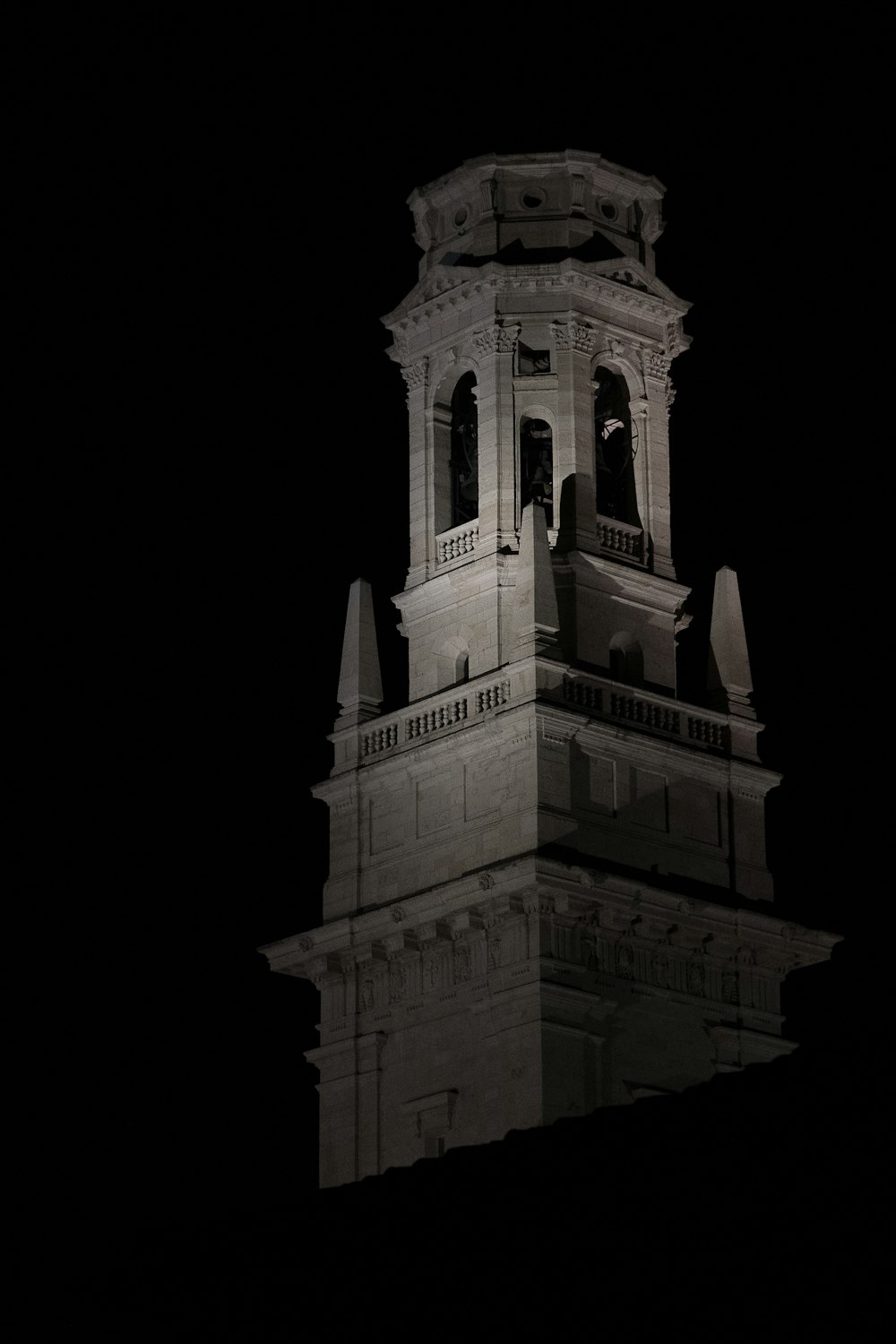 a very tall clock tower with a clock on each of it's sides