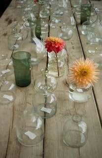 A collection of unique glass vases arranged on a wooden table.
