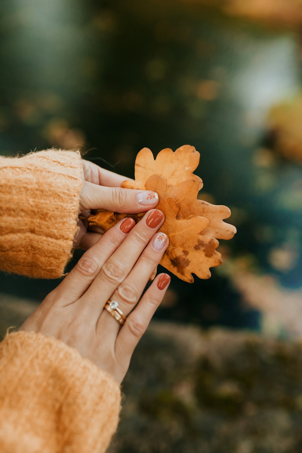 a woman holding a leaf in her hand