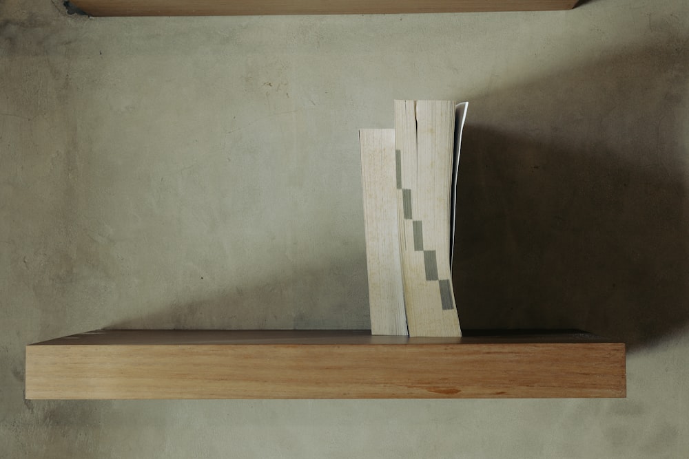 a wooden shelf with a book on top of it
