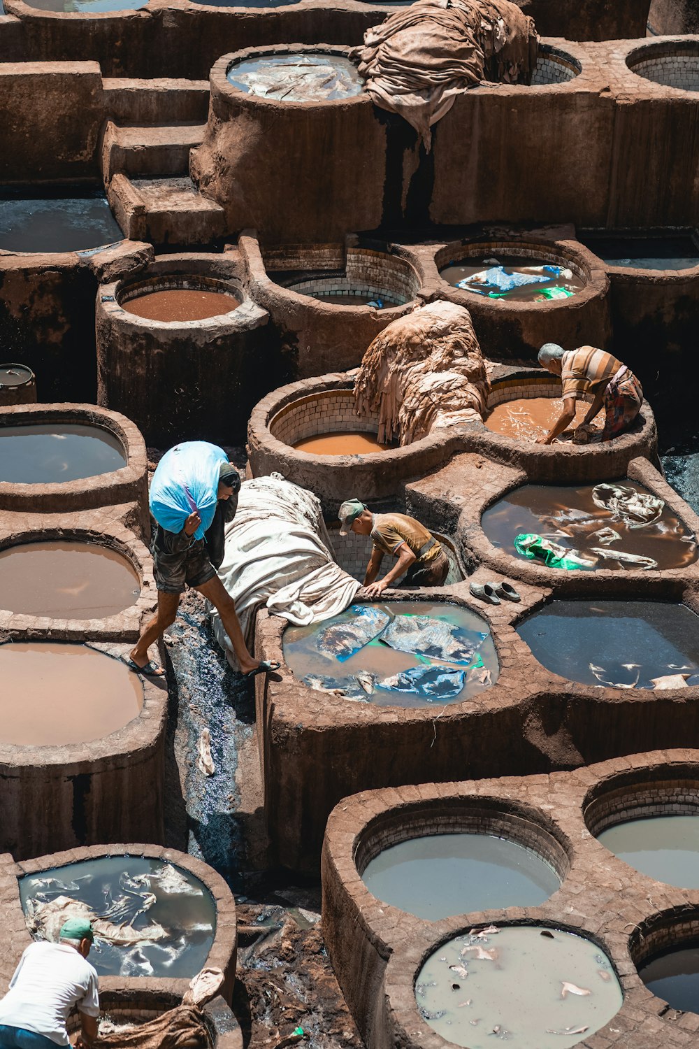 a person standing in front of a bunch of buckets filled with water