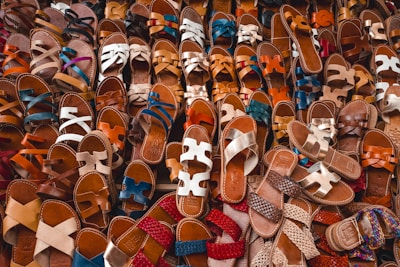 A collection of bamboo sandals arranged neatly on a white background emphasizing simplicity.
