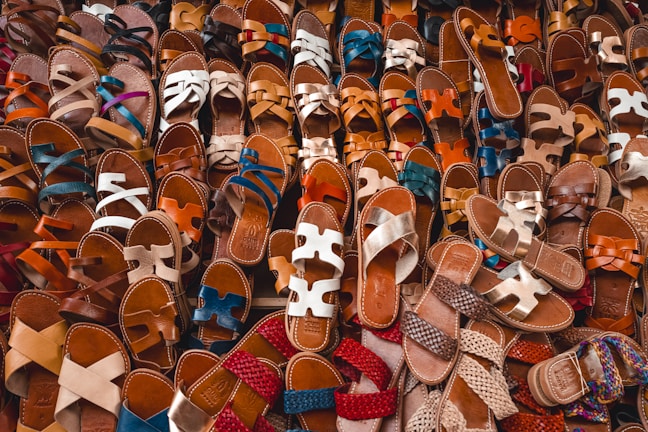 A collection of various stylish sandals arranged neatly.