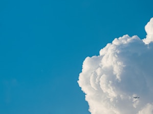 A vibrant image of an airplane flying in a clear blue sky.