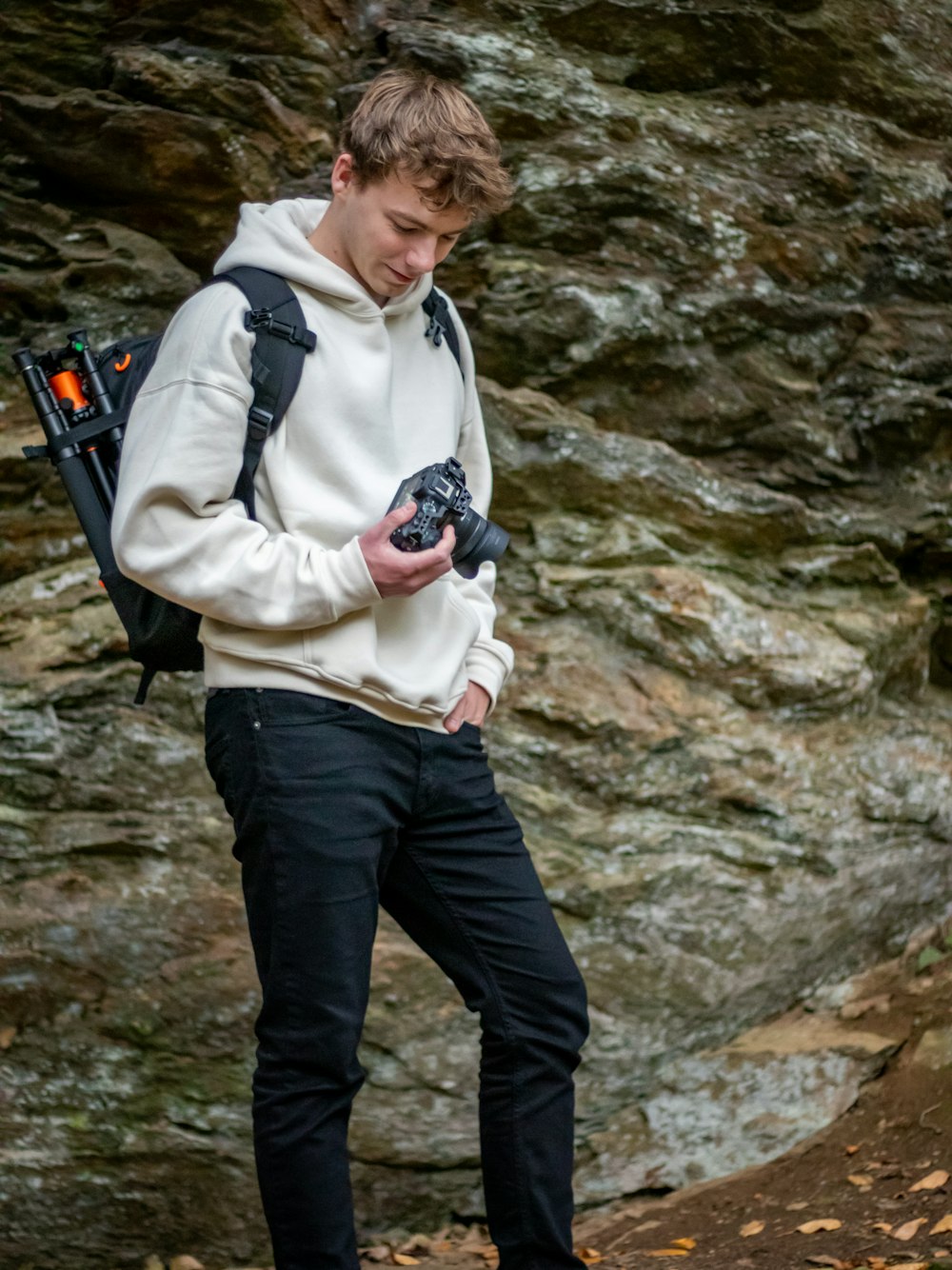 a young man holding a camera in his hands