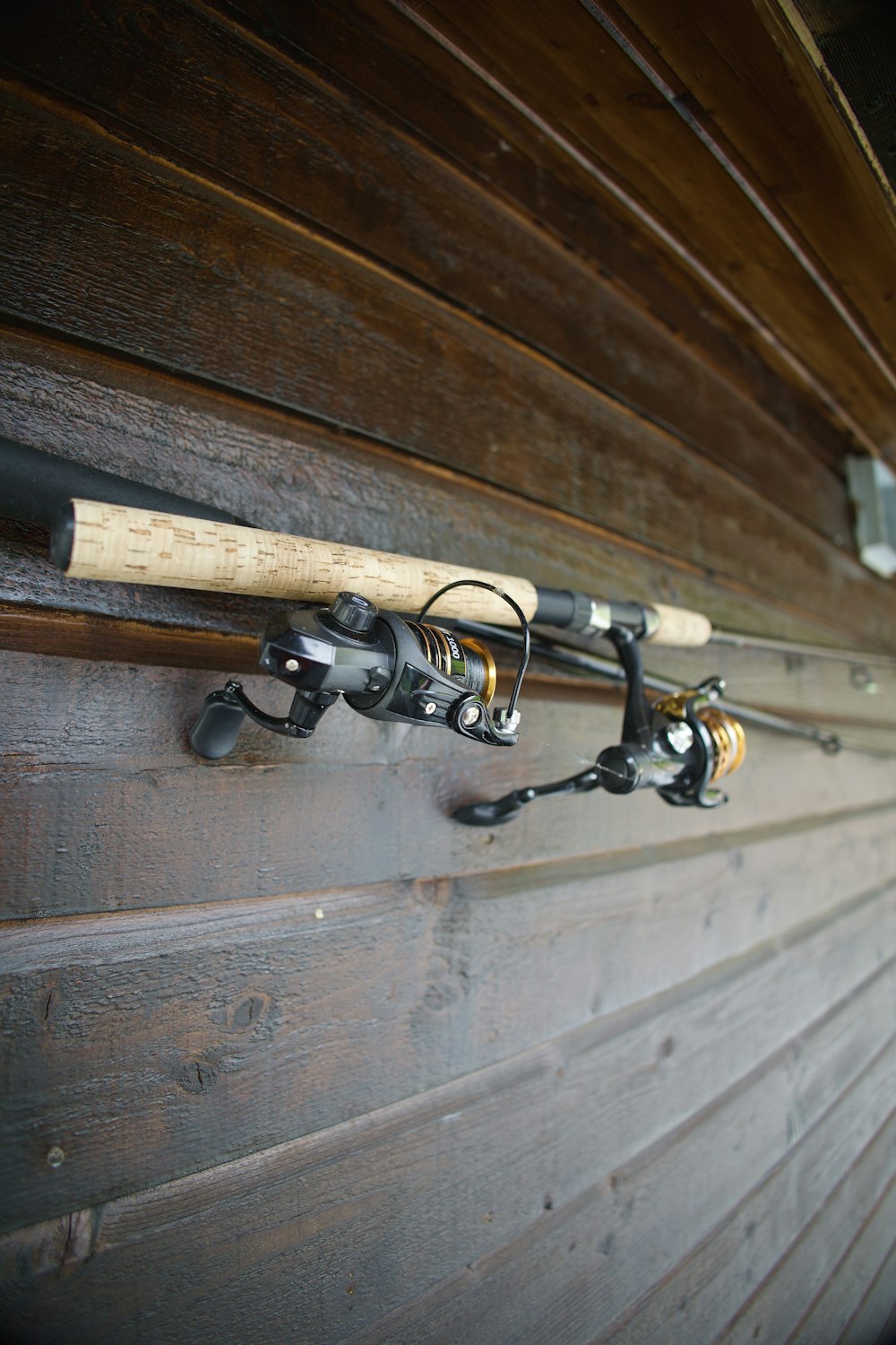 a close up of a fishing rod on a wall