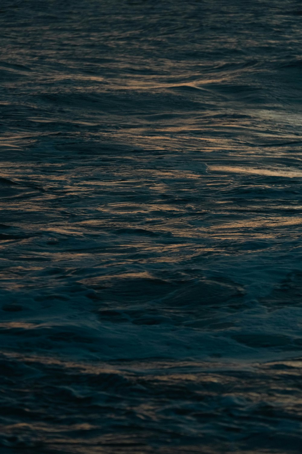 a person riding a surfboard on top of a body of water