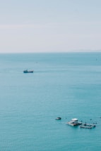 A serene ocean view with shrimp farming in the background.