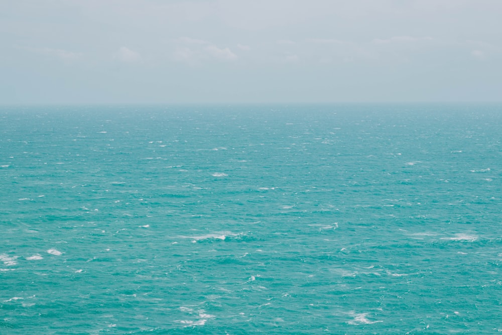 a large body of water sitting under a cloudy sky