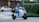 A happy customer test-riding an electric scooter.