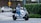 A customer showcasing their electric scooter in a city setting.