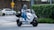 Customer Mark S. showcasing his electric scooter in a city setting.