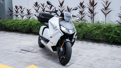 Round image of a sleek electric scooter with a clean white backdrop