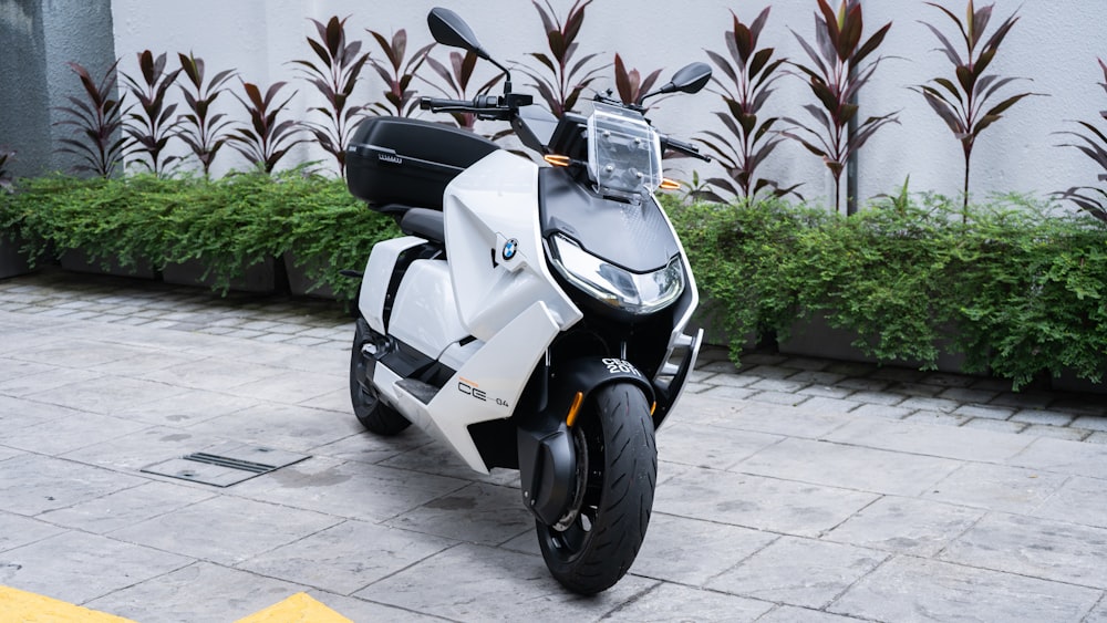 a white and black motorcycle parked in front of a building