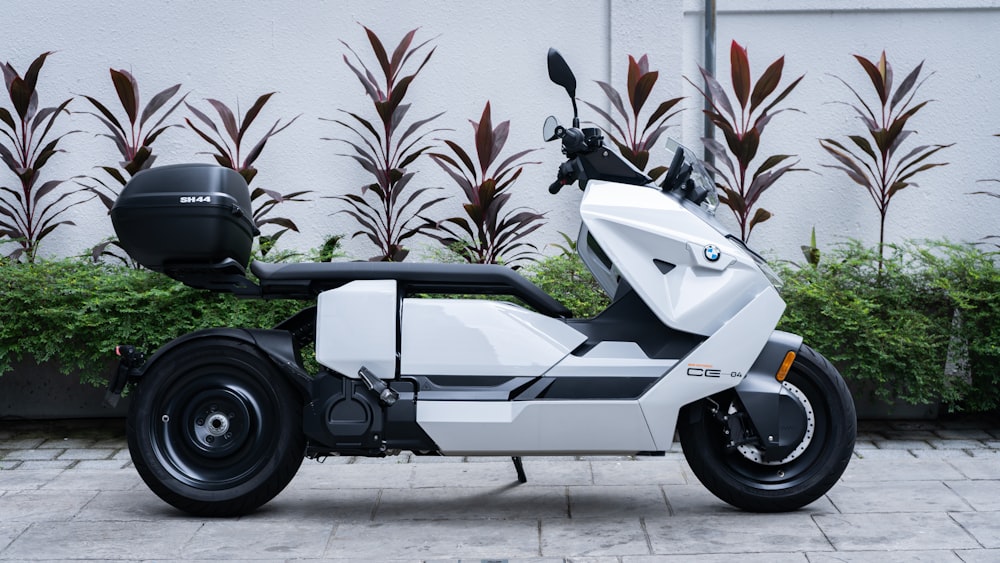 a white motorcycle parked in front of a building
