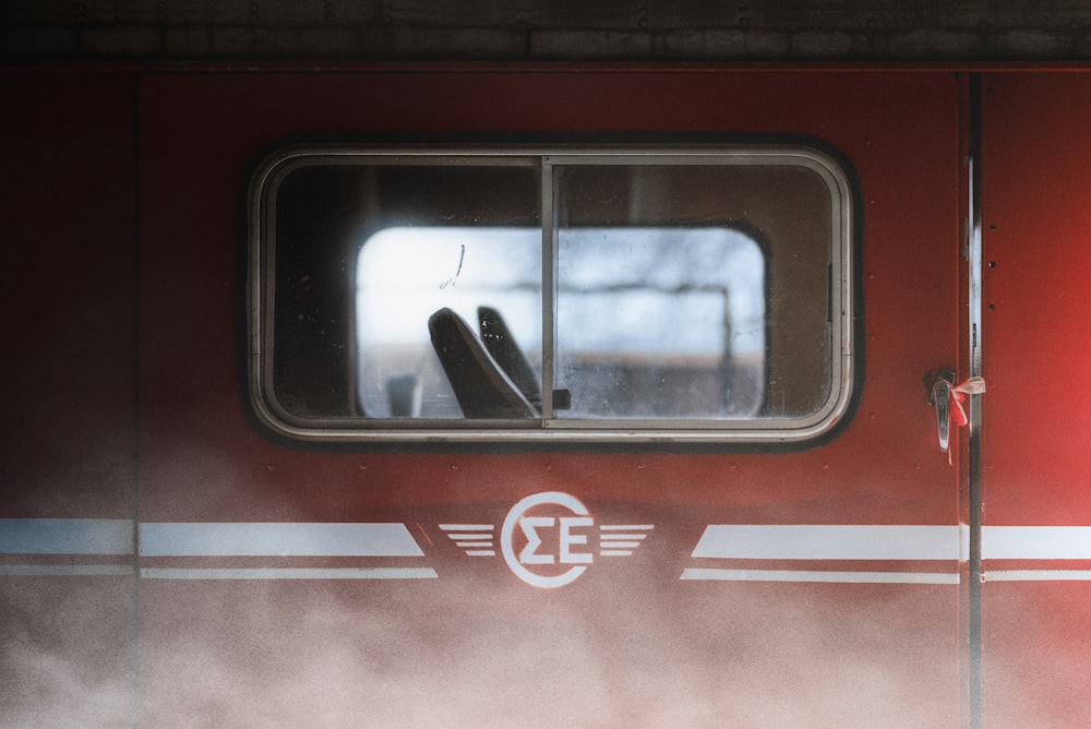 a close up of a train window with steam coming out of it