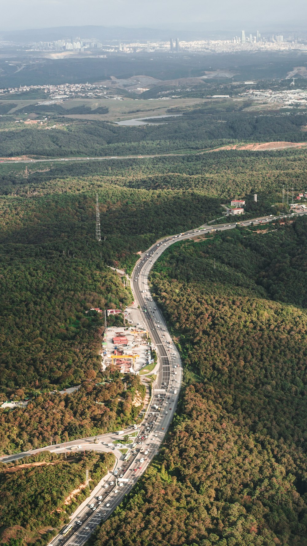 an aerial view of a highway surrounded by trees