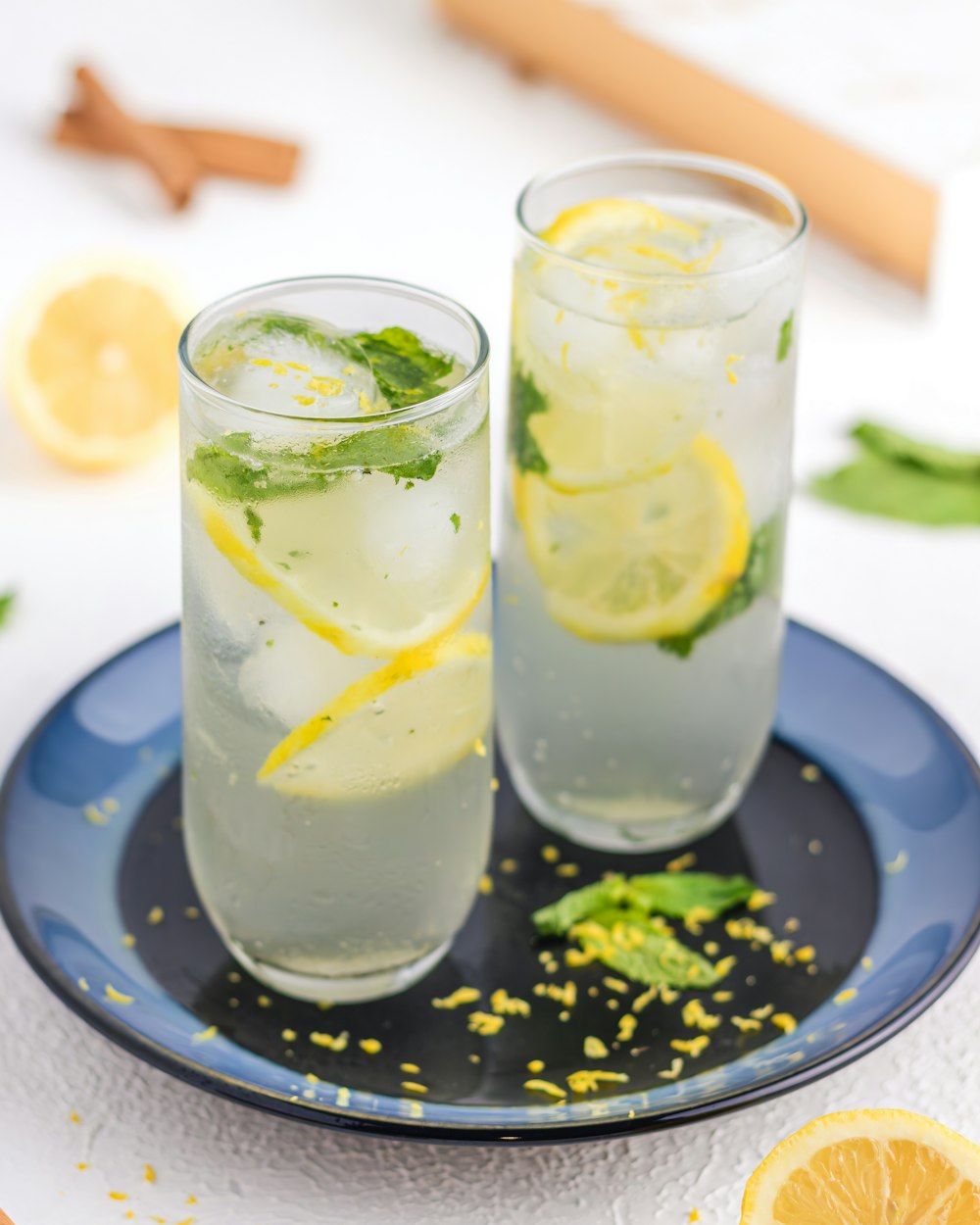 two glasses of lemonade on a blue plate