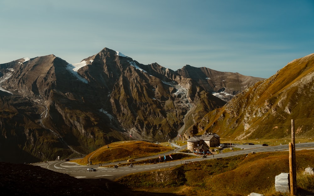 a scenic view of a mountain with a road going through it