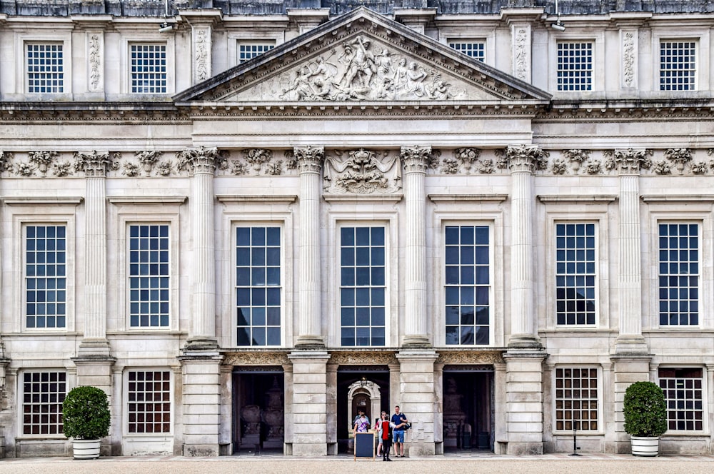 two people standing in front of a large building