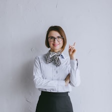 a woman wearing glasses and a bow tie