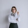 a woman wearing glasses and a bow tie