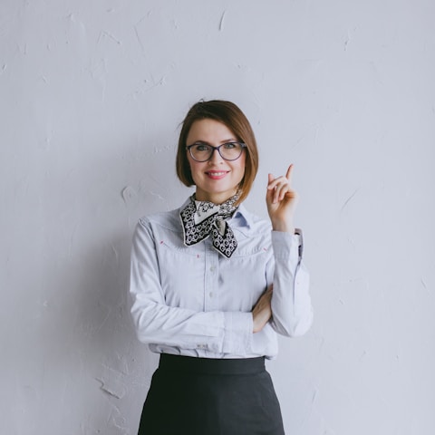 a woman wearing glasses and a bow tie