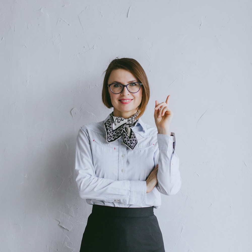 a woman wearing glasses and a bow tie