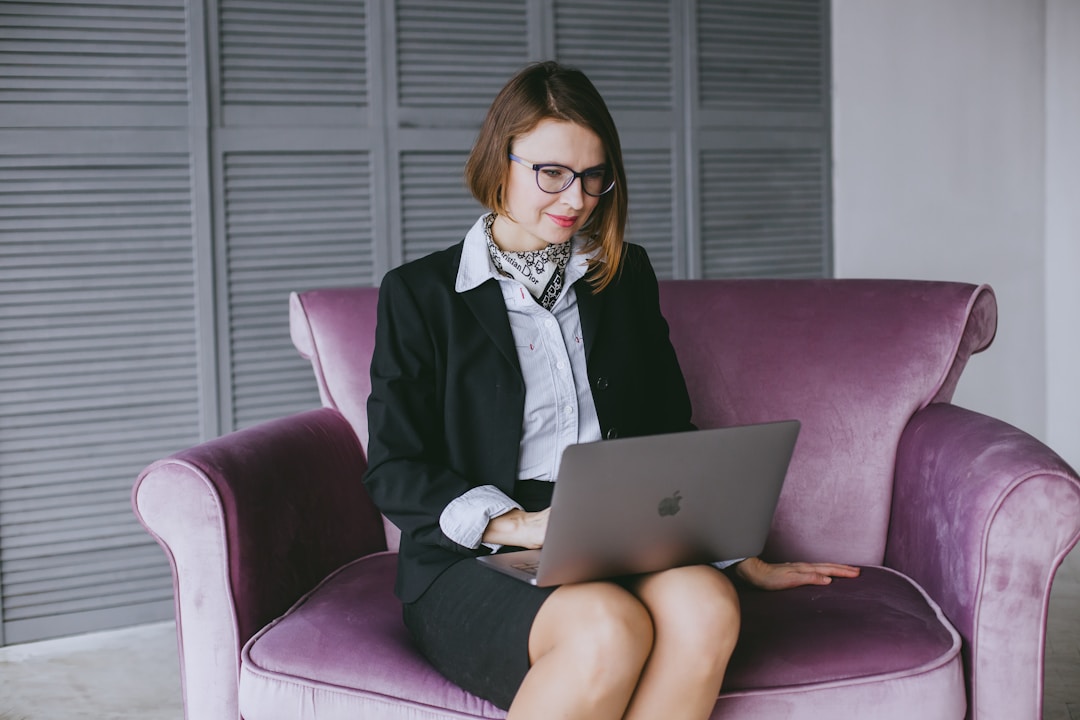 A professional woman using a laptop to enhance customer journey experiences.