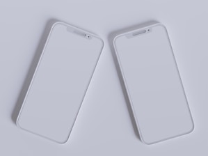 Close-up of hands comparing two tech gadgets side by side with a bright, clean background.