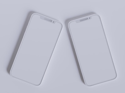 Close-up of hands comparing two tech gadgets side by side with a bright, clean background.