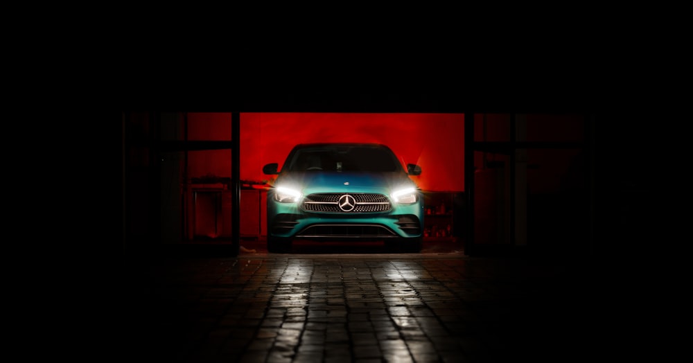 a car parked in front of a red wall