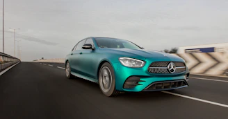 A Mercedes S-Class driving smoothly along a scenic canal road in Amsterdam.