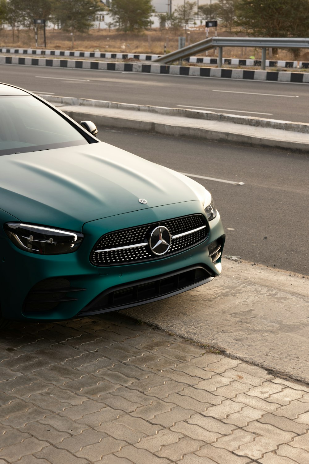 a green car parked on the side of the road