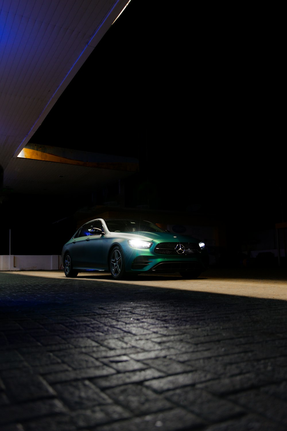 a car parked in front of a building at night