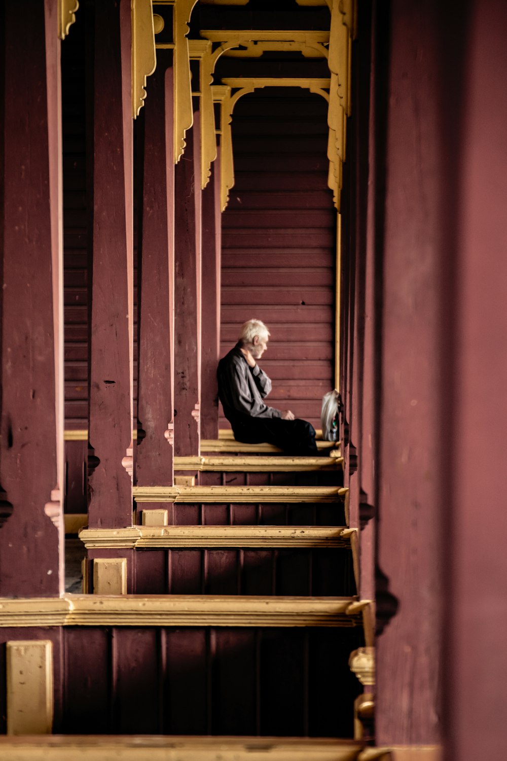 a man sitting on a set of stairs in front of a building