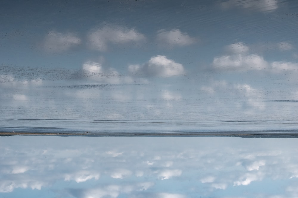 a large body of water surrounded by clouds