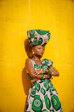 a woman in a green and white dress and hat