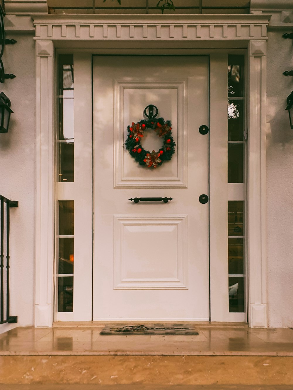 a white front door with a wreath on it