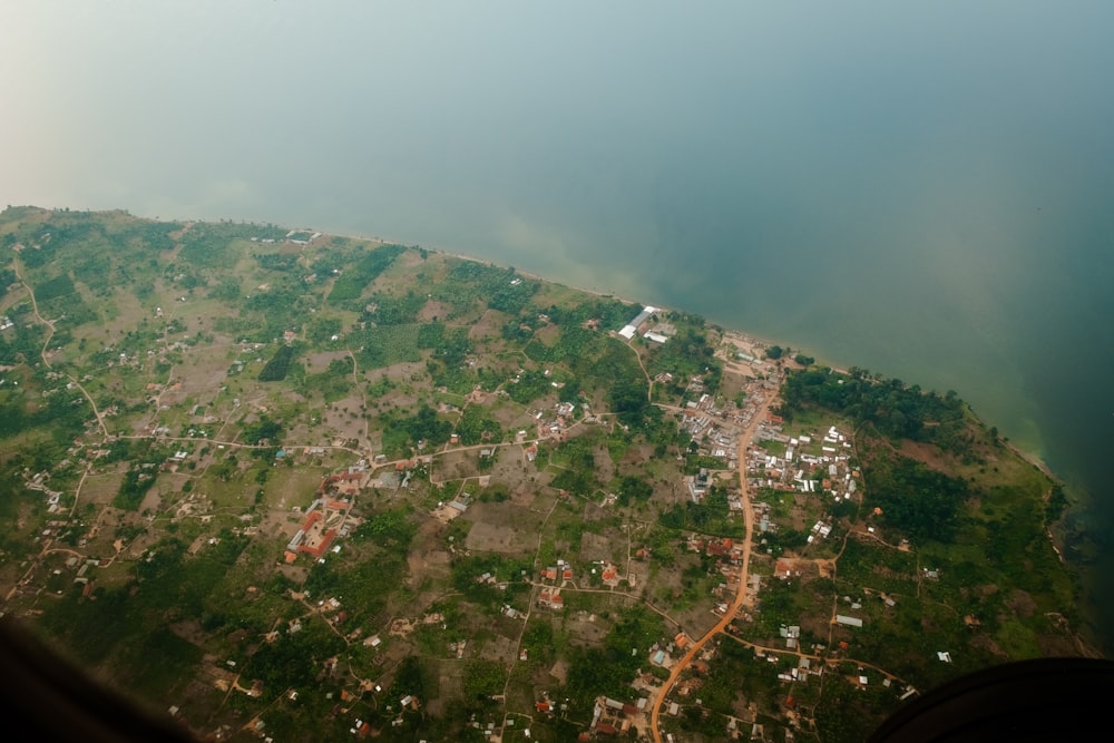 an aerial view of a small town and a lake