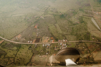 Aerial view of a rural property with drone capturing georeferencing data.