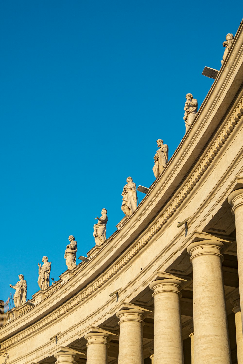 a row of statues on top of a building
