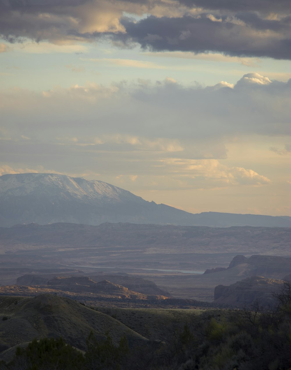 a view of a mountain range with clouds in the sky