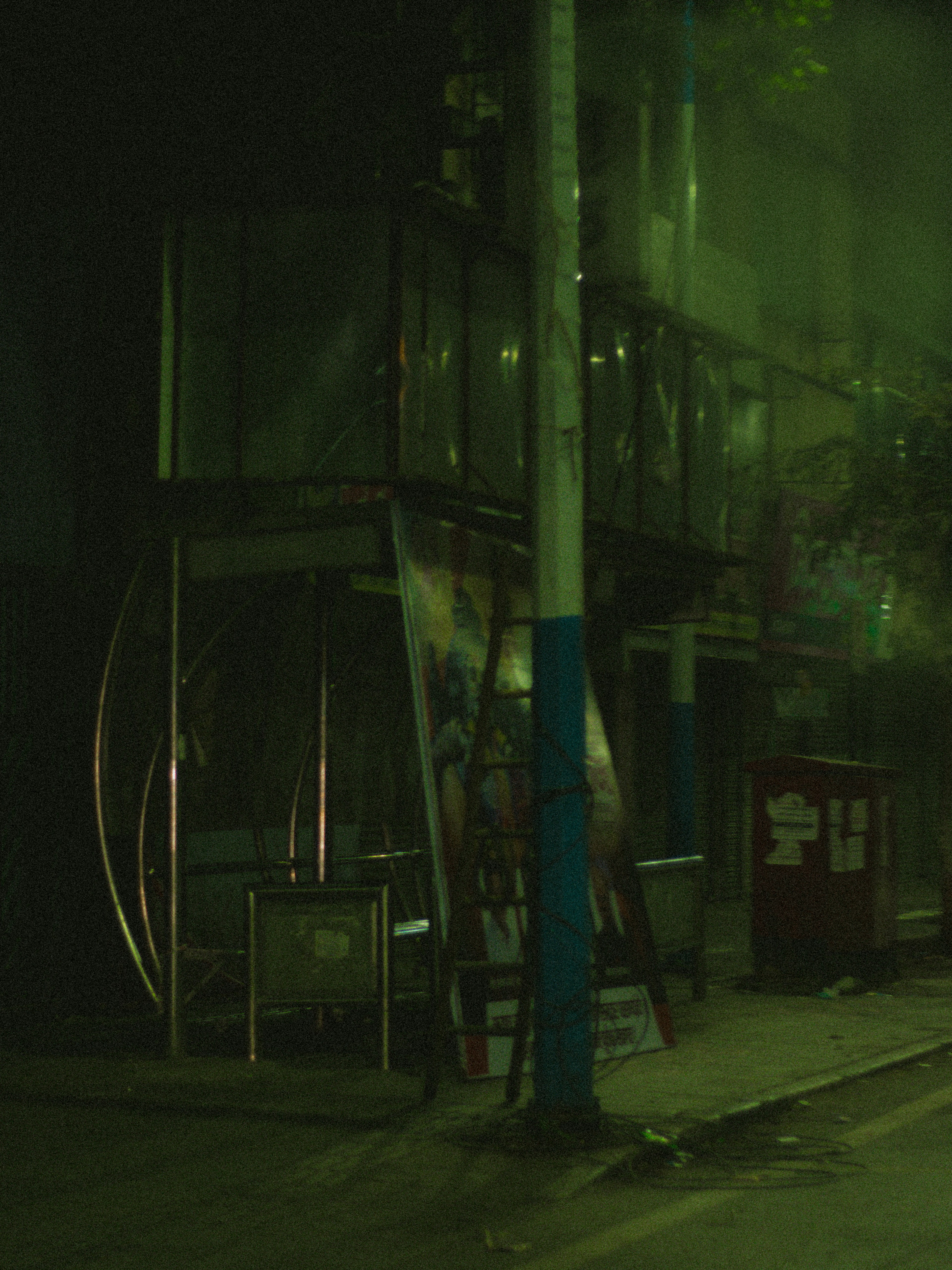 a dark street at night with a fire hydrant on the side of the street