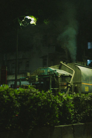 Technician operating a suction truck during a nighttime emergency plumbing service.